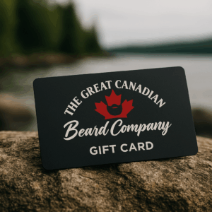 Great Canadian Beard Company® gift card placed on a rustic outdoor surface with a water and rock background.